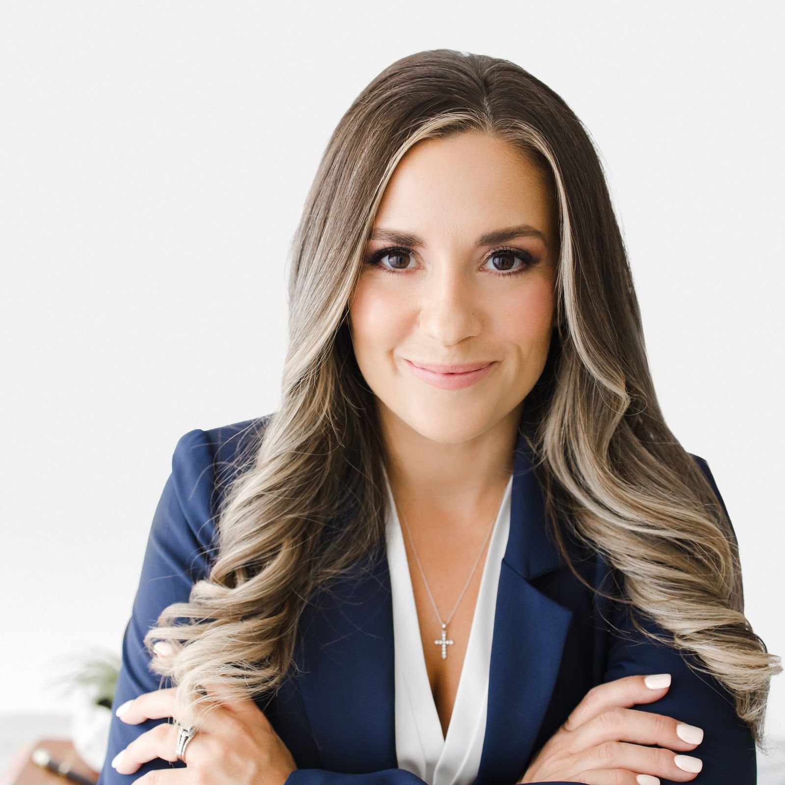 Jessica Pickles in a navy blazer, arms folded